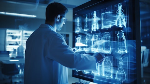 A technician in a lab coat inspecting an X-ray imaging component.