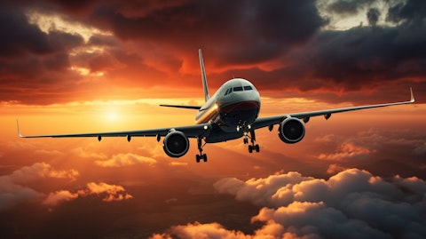 A commercial jetliner, flying high against the backdrop of a dramatic sunrise.