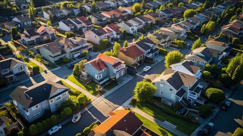 Aerial view of a standard residential neighborhood with multiple rows of relatively new houses representing the company's real estate investments.