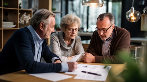 An elderly couple consulting with a financial advisor on their retirement investments.