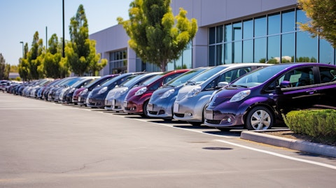A line of electric vehicles parked in front of a research & development building in San Jose, California.