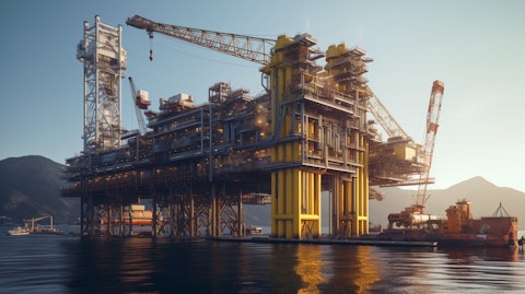 A side view of a heavy industrial crane in operation, lifting an oil rig tower.