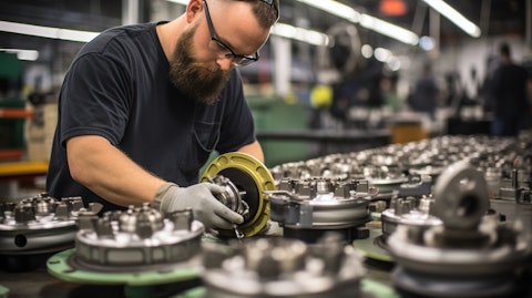 A production line worker overseeing the production of driveline components.