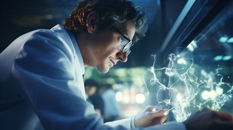 A close up of a scientist in a labcoat admiring the progress of a biotech experiment.