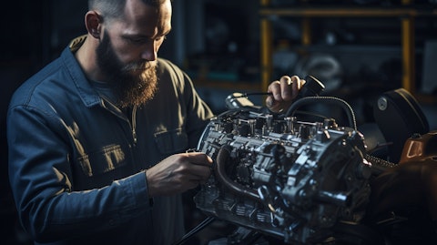 An engineer inspecting an automobile engine powered by thermal management products.