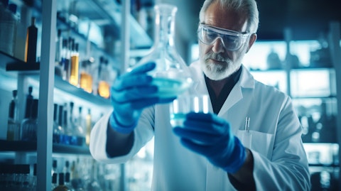 A scientist holding a flask of liquid in a laboratory, highlighting the research and discoveries of new treatments.