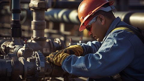 A gas pipeline worker inspecting a valve in an industrial setting.