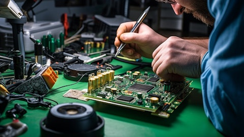 A close-up of a technician's hands assembling electronic components on a circuit board.