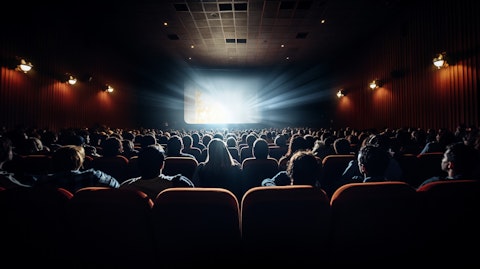 An audience of moviegoers inside a theatre, savoring the latest cinematic experience.