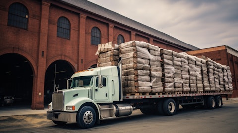 A truck loaded with cigarettes parked in front of a tobacco warehouse.