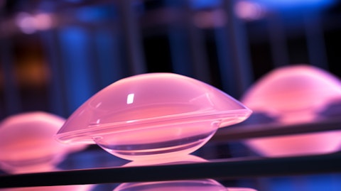 A close-up of a silicone gel-filled breast implant with a Motiva logo in the background.