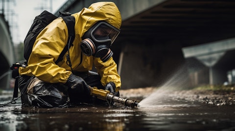 A worker in a protective jumpsuit using specialized equipment to manage well flow.