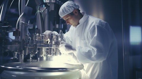A close-up of a technician mixing ingredients in a large food processing factory.