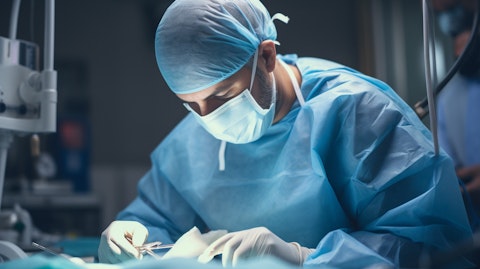 A specialist surgeon in the operating theatre performing a hernia repair.
