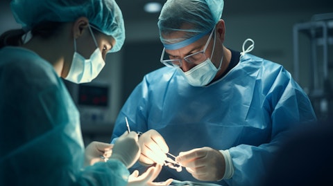 A healthcare professional putting the finishing touches on a patient's knee implant in an operating theater.