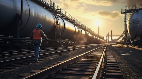 A worker measuring crude oil inside a rail tank car.