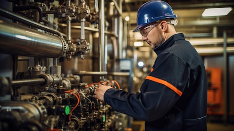 An oil and gas engineer looking at a production tree, inspecting its pressure control equipment.