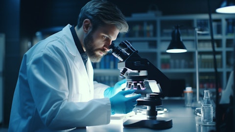 A scientist in a lab coat working on a microscope in a sophisticated biotechnology lab.