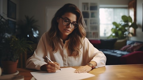 A woman signing a healthcare plan document in her home office.
