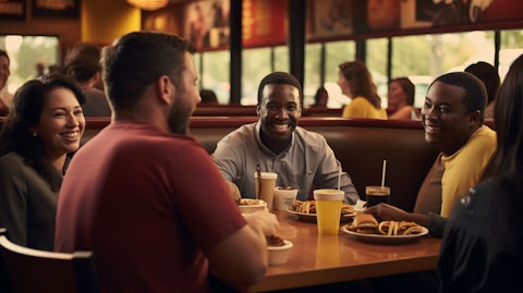 A close-up of a table of people enjoying their meal and conversing in a Denny's restaurant.