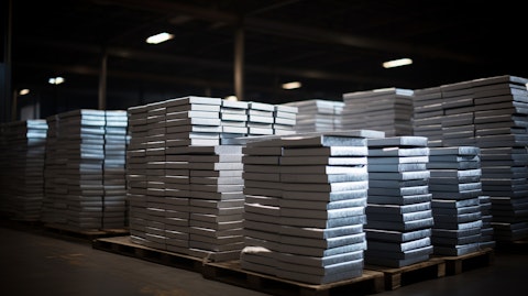 A warehouse of aluminum ingots, neatly lined up ready to be shipped.