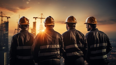 A team of workers wearing the company's protective wear, looking off into the dawn.