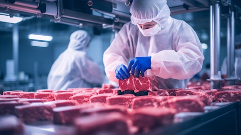Workers bottling plant-based meat products on an automated production line.