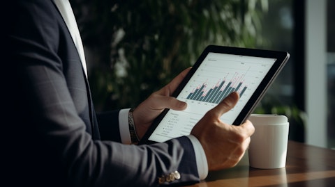 Close-up on a business executive holding a tablet with a graph indicating an upward trend.