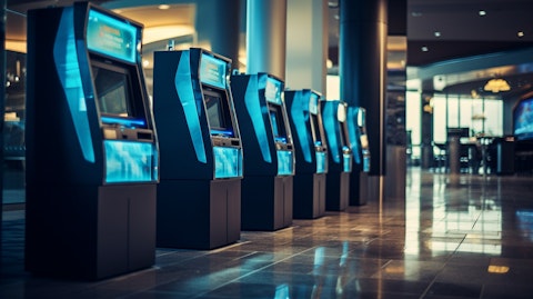 A row of sophisticated full-service ATMs in an airport lounge, ready to serve customers.
