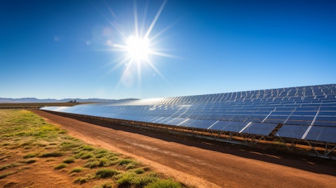 A panoramic view of a concentrated solar power plant swathed in bright sunshine.
