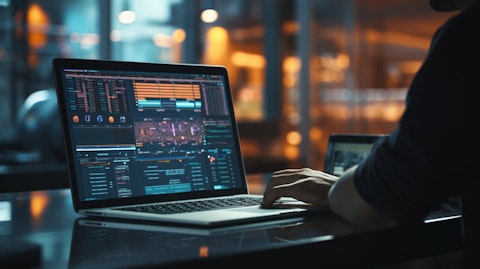 Closeup of a software engineer in front of a laptop coding a modern platform.
