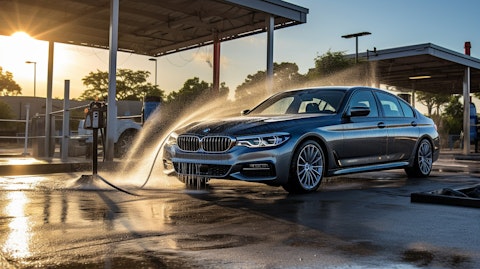 A car being expeditiously washed and cleaned onsite at a car wash service location.