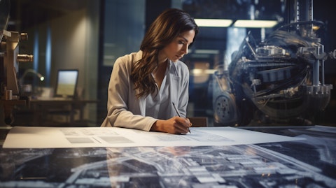 An engineer in her office examining a blueprint, surrounded by engineering components.