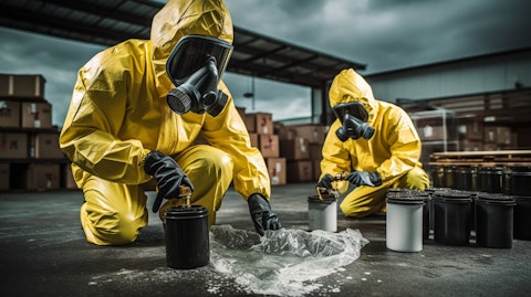 A specialist cleaning service team in full protective equipment removing hazardous waste.