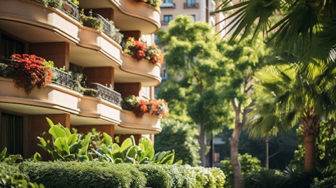 A close-up of a luxurious apartment building, surrounded by lush landscaping.
