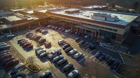 Aerial view of a healthcare facility with a bustling parking lot.