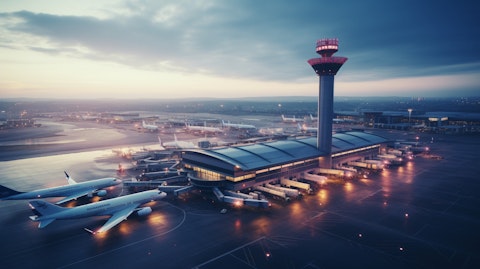 An aerial view of a busy airport, its control tower standing tall.