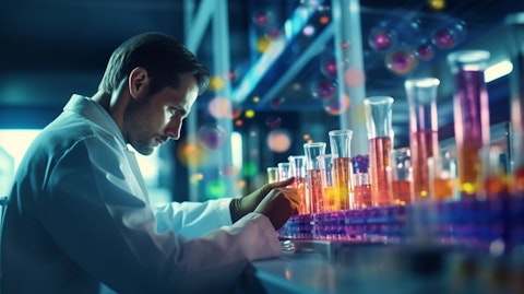 A scientist studying a pipette of colorful molecules in a laboratory.