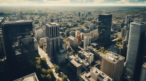 Aerial view of a bustling cityscape with a high-rise office building in the centre.