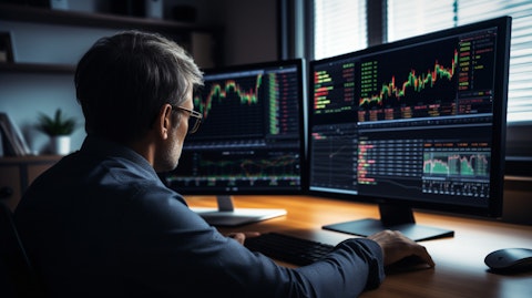 An experienced financial analyst using a computer to review market trends and allocate funds.