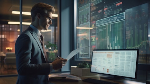 A business executive in a modern office looking over reports detailing artificial intelligence.