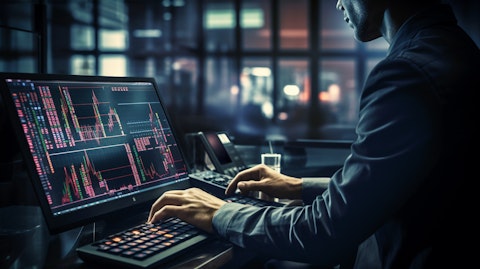 A trader on a busy trading floor, his hands on a keyboard as the markets rise.