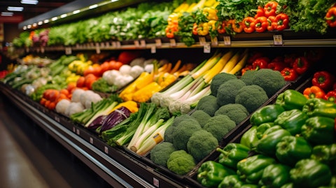 A busy produce section in a grocery store, with heaps of fresh fruits and vegetables.