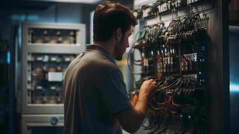 A technician operating a power control module at a laboratory station.