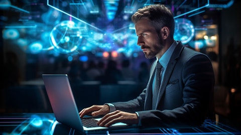 A technology executive in front of a laptop, illustrating the company's digital capabilities.