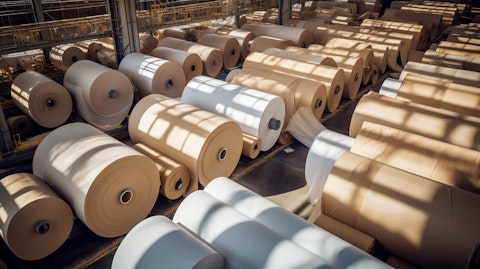 An aerial view of a paper mill filled with massive rolls of papers.