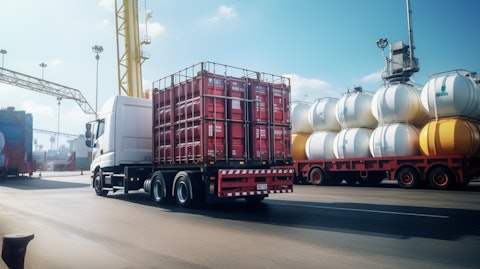 A truck filled with barrels of polymers and resins leaving a chemical production plant.