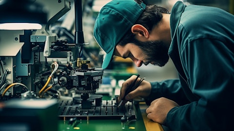 A worker inspecting a precision component on a factory floor.