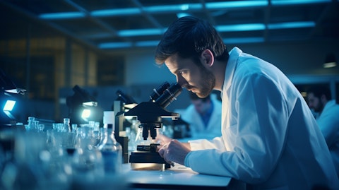 A lab technician gazing into a microscope, analyzing sample slides for medical technology research.