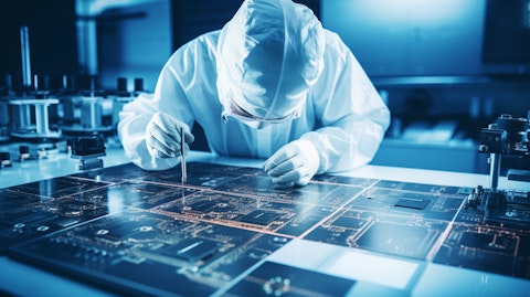 A lab technician inspecting intricate SEM micrographs of semiconductor interconnects.